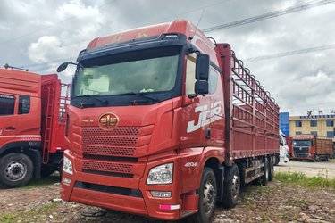 二手青岛解放 JH6重卡 420马力 8X4 9.4米仓栅式载货车(国五) 前四后八 锡柴二手载货车 黄牌图片