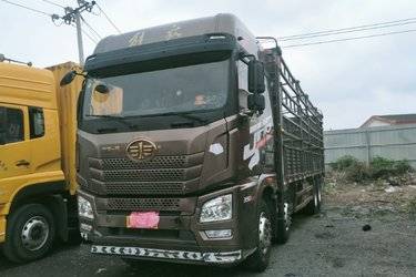 二手青岛解放 JH6重卡 350马力 8X4 9.5米仓栅式载货车(国五) 前四后八 锡柴二手载货车 黄牌图片